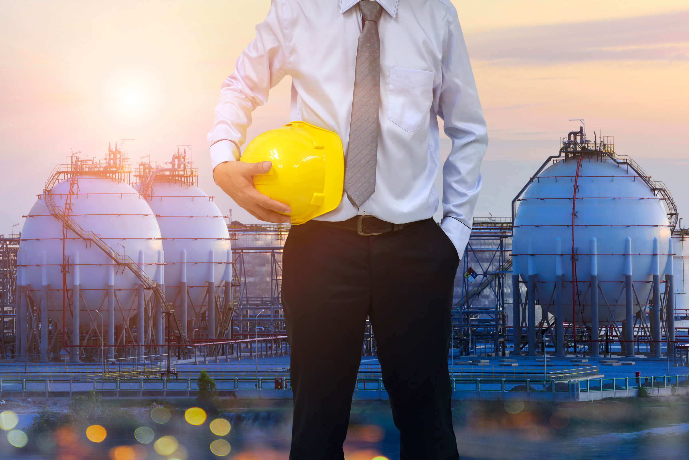 Construction concept . engineer  holding helmet and blur construction background . Occupational health and safety .